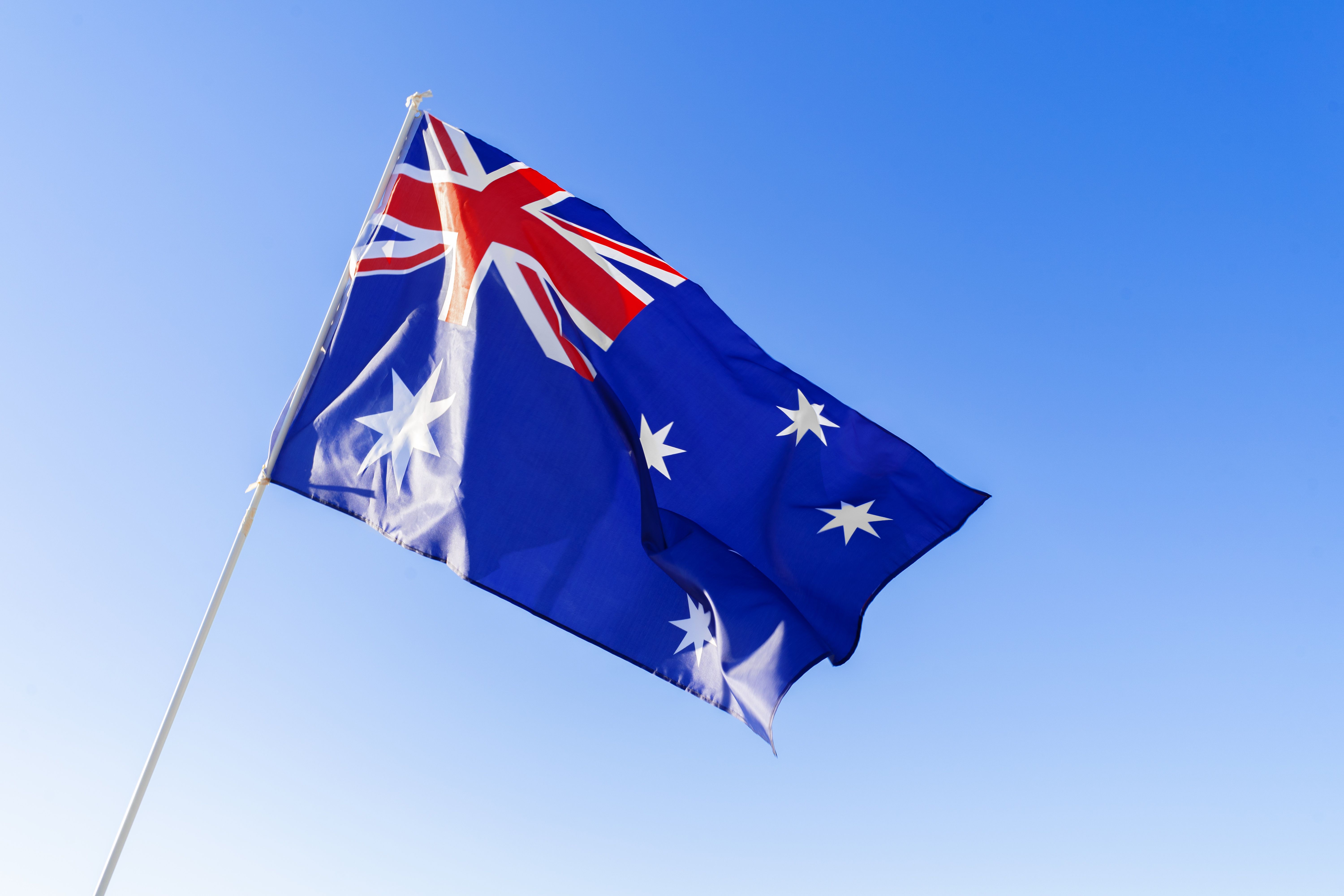 flag-of-australia-waving-against-blue-sky-2023-11-27-05-08-47-utc.jpg