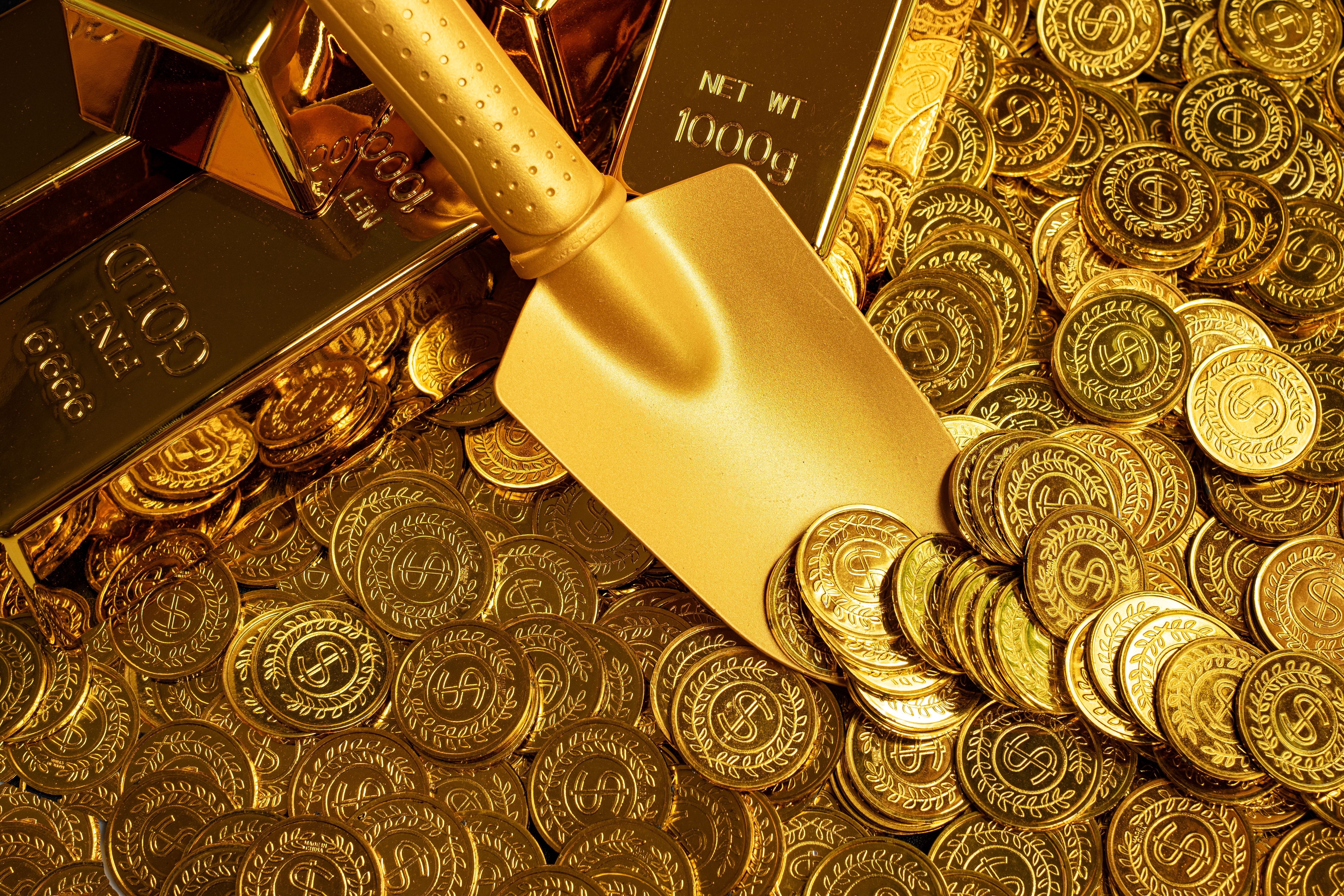 golden-shovel-scooping-up-piles-of-gold-coins-and-2023-11-27-05-10-39-utc.jpg