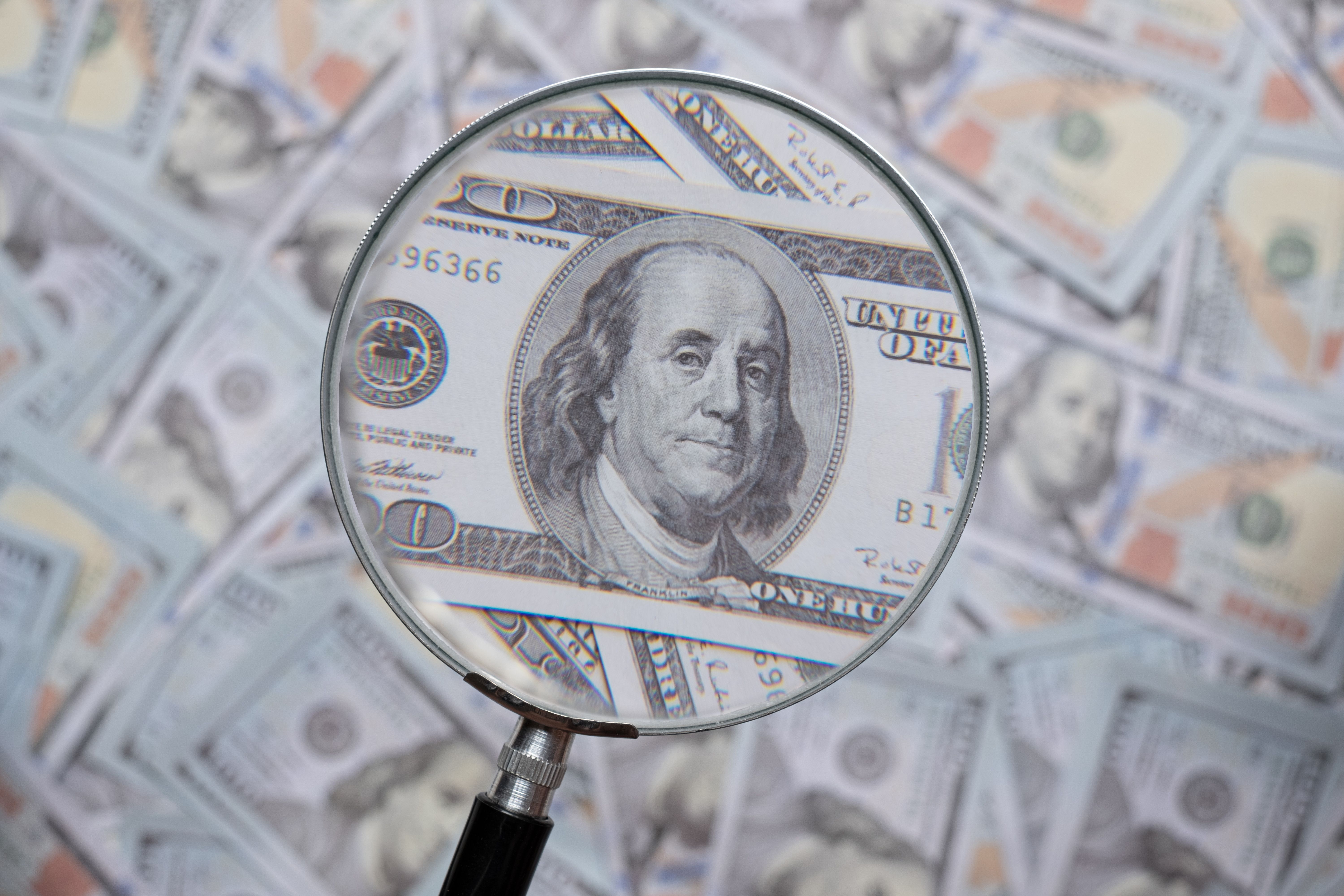 hundred-us-dollar-bill-through-magnifying-lens-che-2023-11-27-05-16-45-utc.jpg