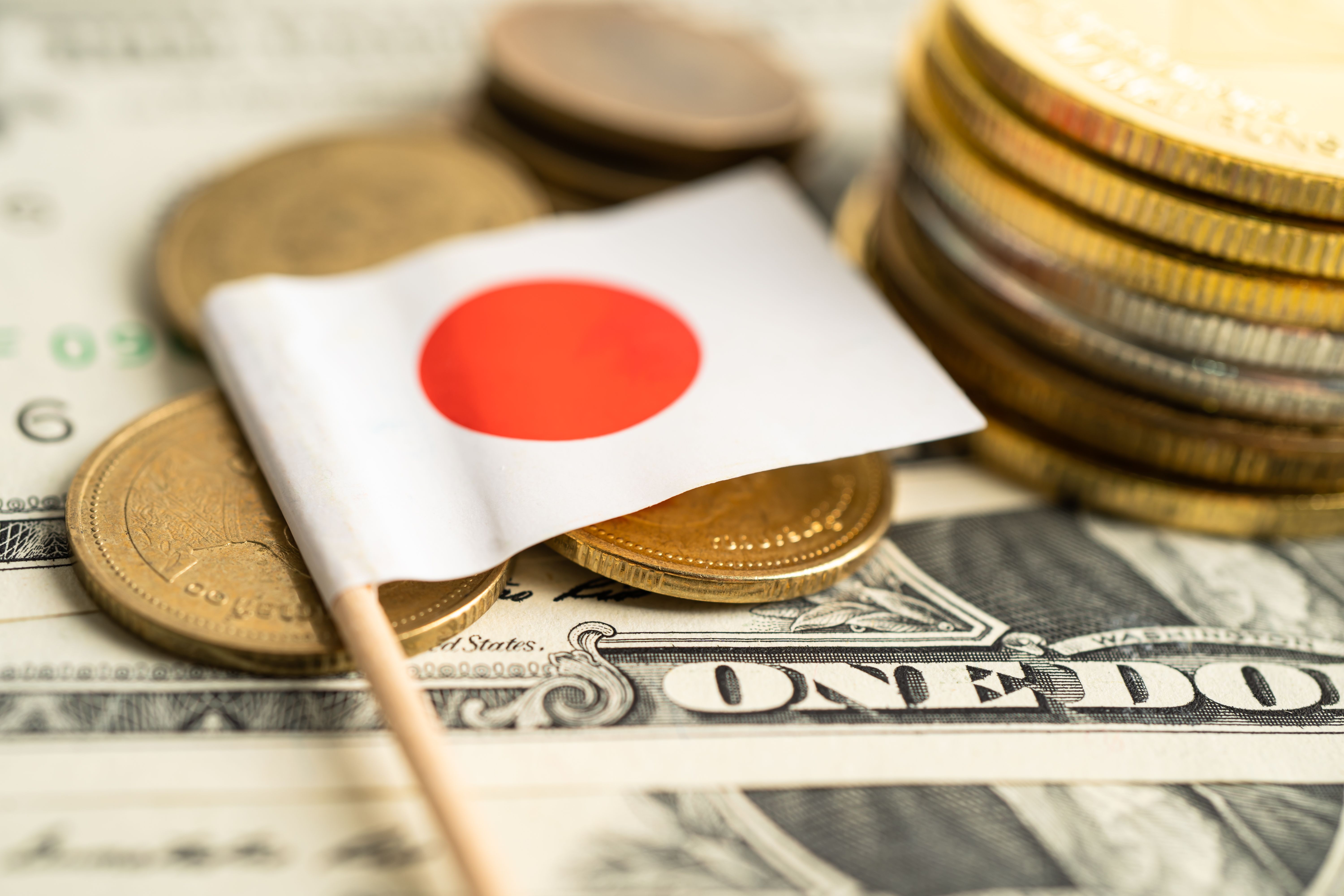 stack-of-coins-with-japan-flag-and-us-dollar-bankn-2023-12-12-02-18-52-utc.jpg