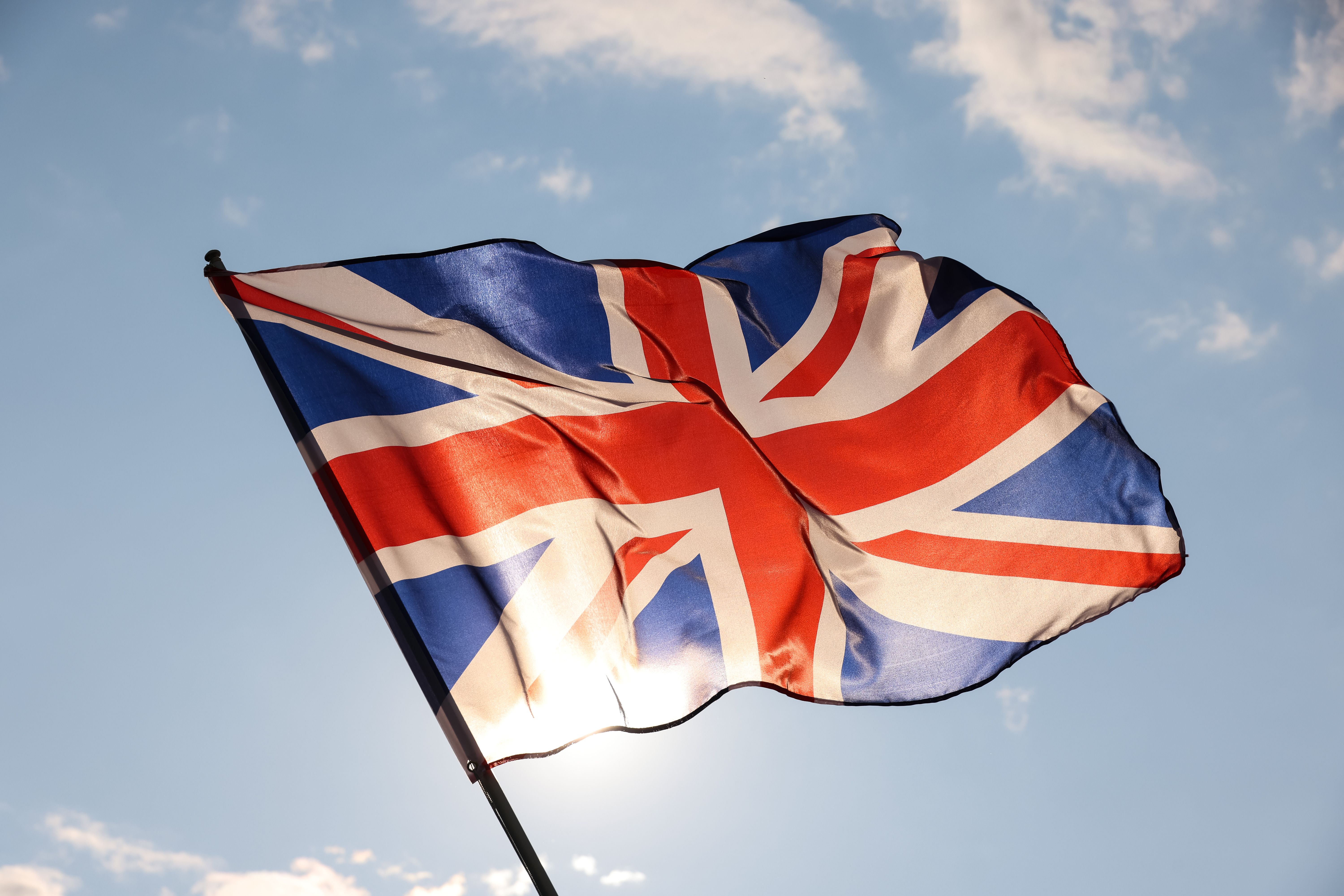 uk-great-britain-flag-waving-in-cloudy-blue-sky-2022-09-16-00-29-49-utc.jpg
